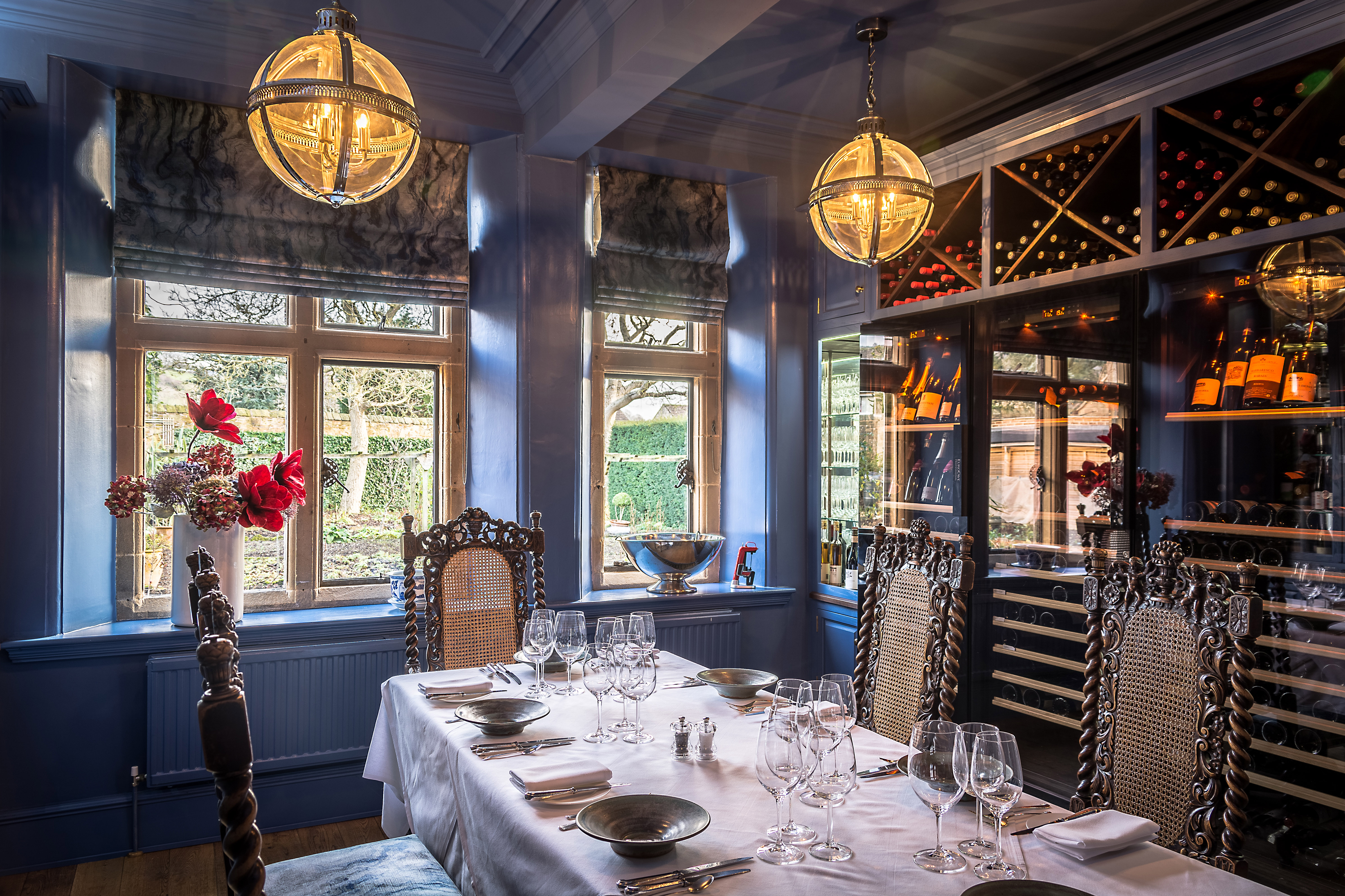 The wine room at Baslow Hall, Derbyshire with cutlery and glasses on the large dining table