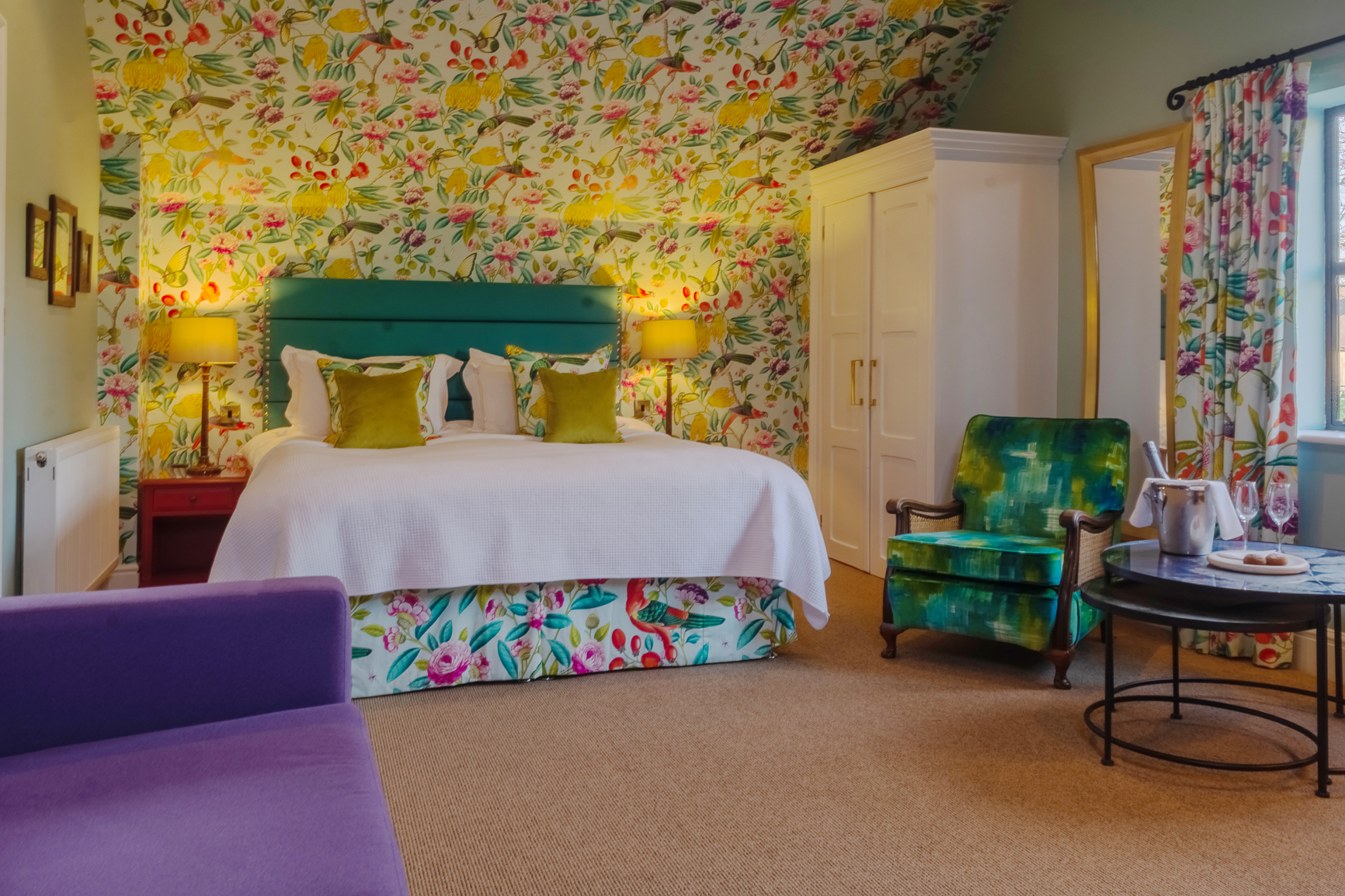 Garden room double bed at Baslow Hall, Derbyshire. Red table lamps either side